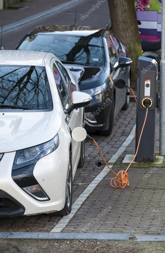 Electric cars plugged in for charging. — Stock Photo © Gleti 125320212
