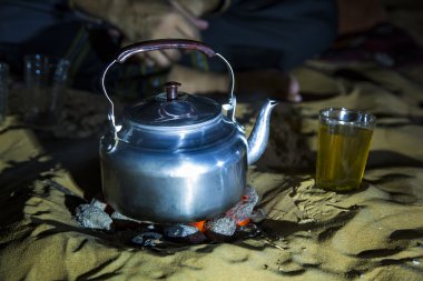 teapot on fire in a desert clipart