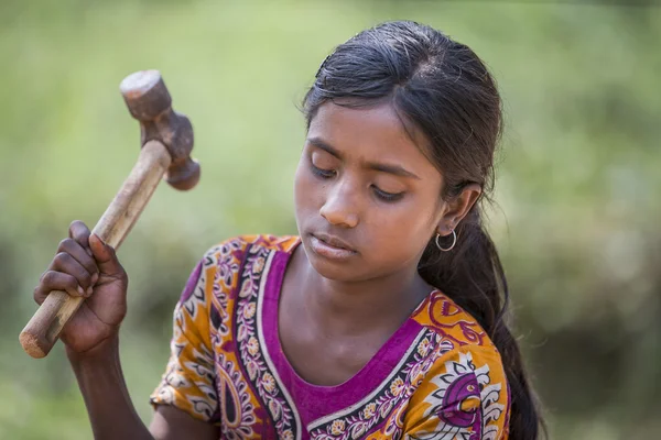 Young girl is destroying old bricks — Stock Photo, Image