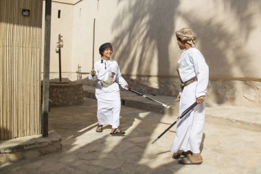 Omani boys with a swords clipart