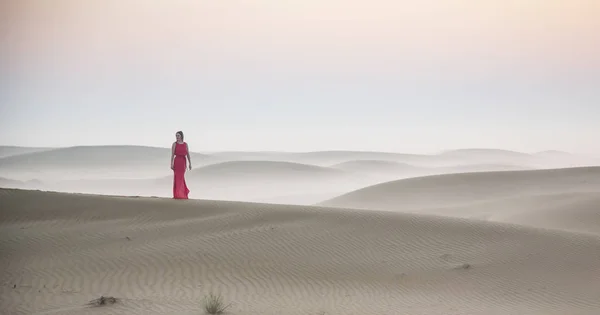 woman standing on sand dune