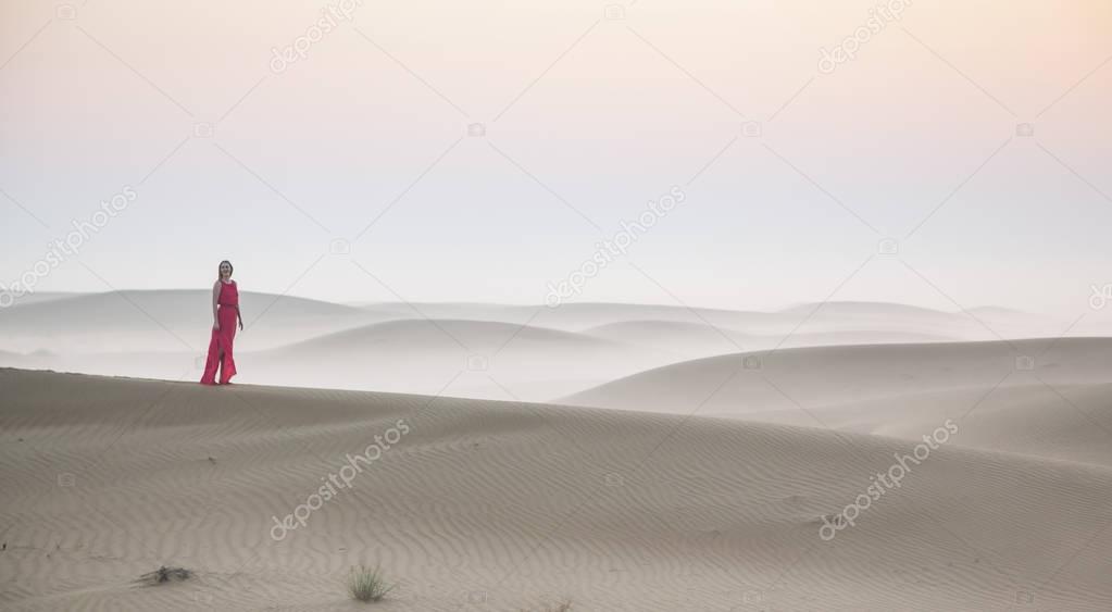 woman standing on sand dune