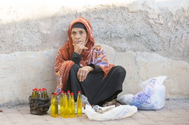 omani lady selling oil  clipart