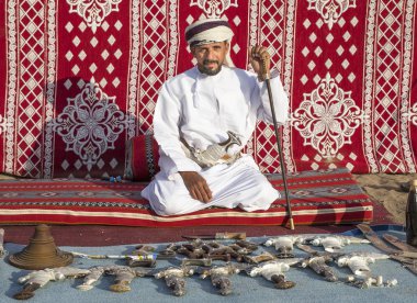 man selling traditional khanjar daggers clipart
