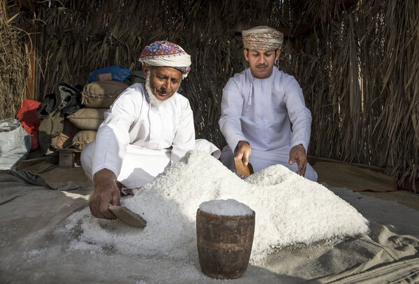 omani men with pile of salt