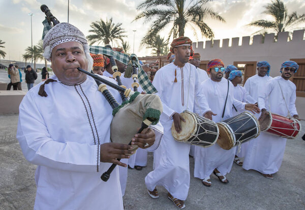 Omani men playing drums and singing