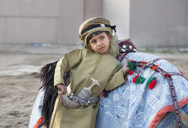 Boy in traditional clothing with camel — Stock Photo, Image