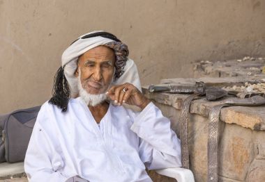 Markette oturan eski Omani adam