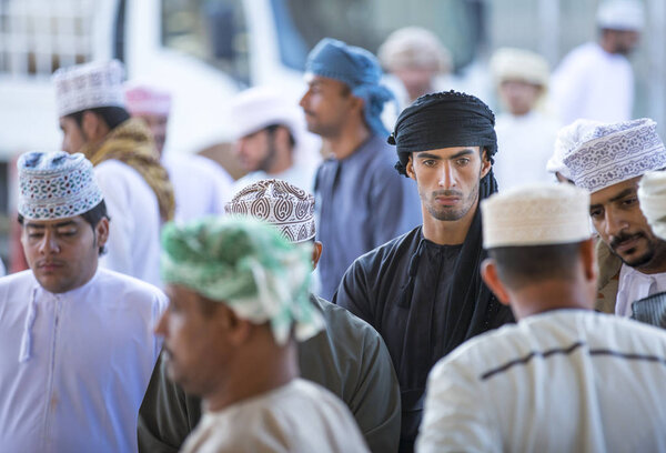 men at a market in Nizwa