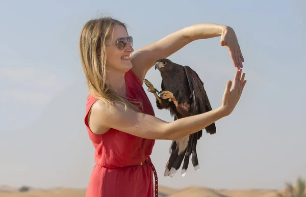 Woman holding greater spotted eagle