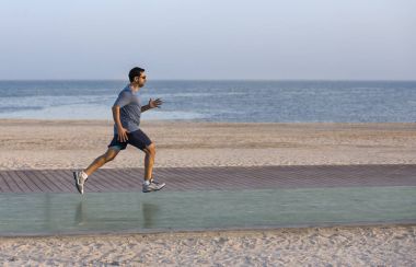 bir koşu parkuru beach yakınındaki üzerinde koşan adam 
