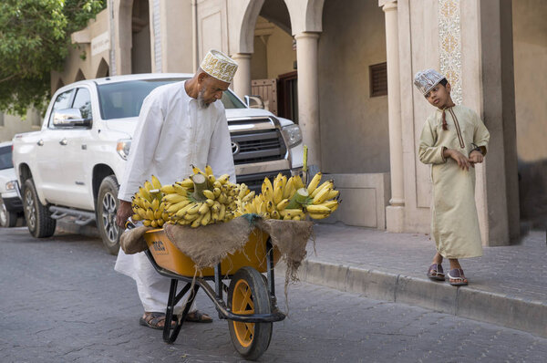  man transporting bananas at street market
