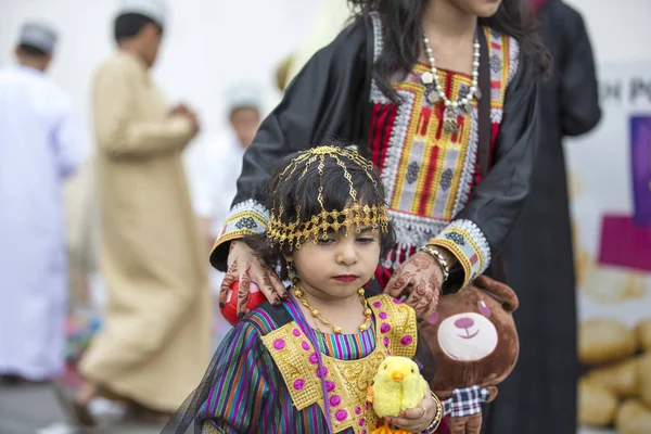 Girl with mother at toy market — Stock Photo, Image