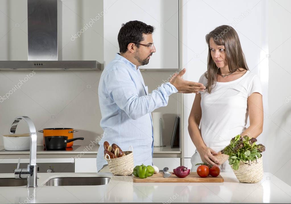 couple preparing food in kitchen 