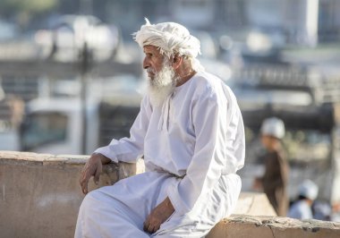 Nizwa, Oman, 10th November 2017: omani old man resting on parapet clipart