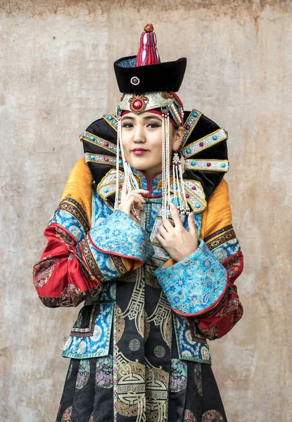 mongolian woman in traditional outfit near old Temple in Ulaanbaatar