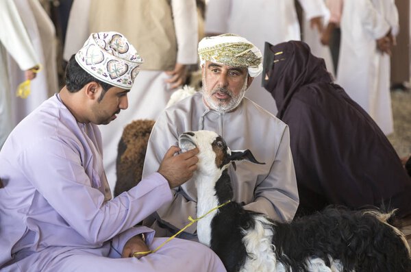 buying goats at a market