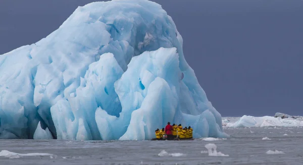 stock image people travelling swimming in zodiac near Massive Monaco Glacier in Archipelago of Svalbard in Norway