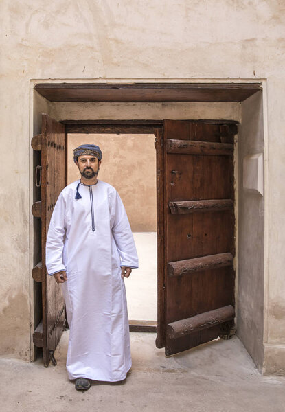 arab man in traditional omani outfit in an old castle