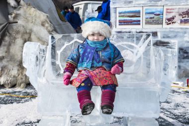 Hatgal, Mongolia, 3rd March 2018: mongolian girl on a frozen lake Khuvsgul during a ice festival in winter clipart