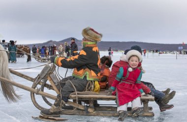 Hatgal, Mongolia - 3rd March 2018: people at the festival on frozen lake Khovsgol clipart