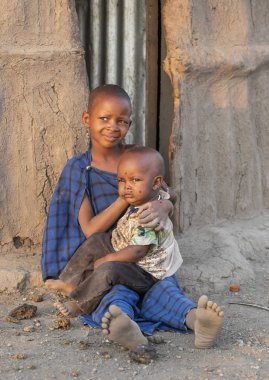 Arusha, Tanzanya, 7 Eylül 2017: Masai kızı kardeşine bakıcılık yapıyor.