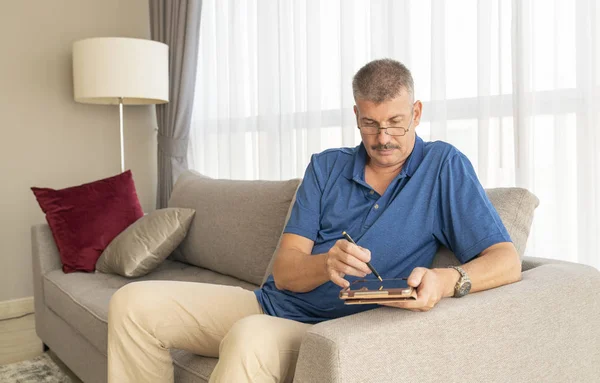 Man Van Middelbare Leeftijd Die Een Bank Aan Zijn Tablet — Stockfoto