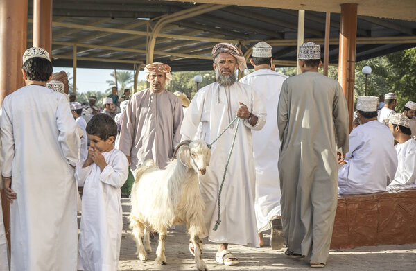Nizwa, Oman, December 2015: omani men socializing at old Nizwa goat market