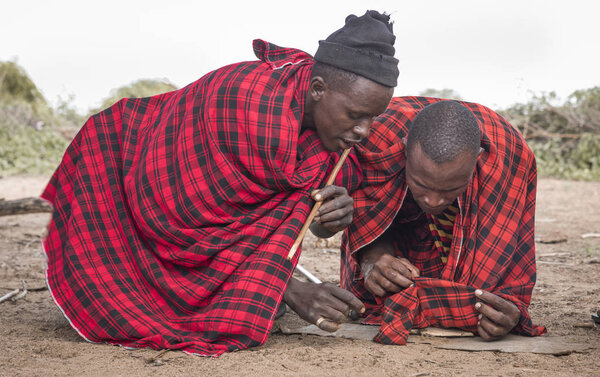 Same, Tanzania, 6th June, 2019: Maasai men making fire