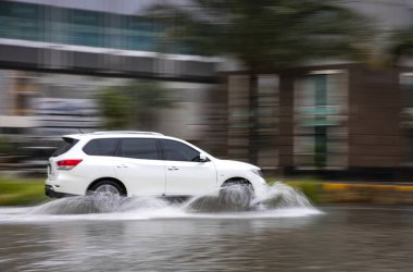 Dubai, United Arab Emirates, 11 January 2020: car driving in flooded street of Dubai after a heavy rainfall
