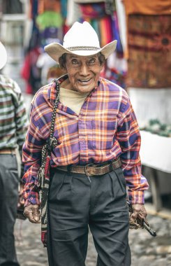 Chichicastenango, Guatemala, 27th February 2020: Old mayan man walking on street