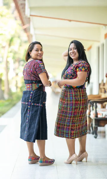 two mayan ladies in their traditional clothing outdoors