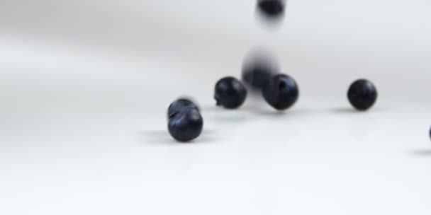 Blueberries dropping onto table — Stock Video