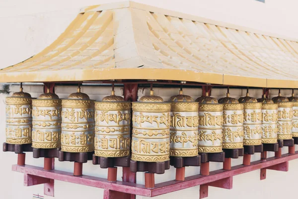 Group of golden prayer wheels typical of Buddhist temples