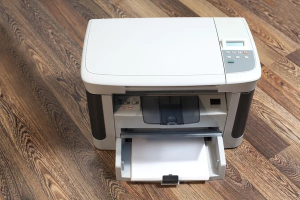 Domestic printer on wooden background — Stock fotografie