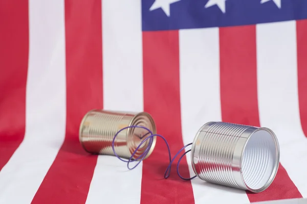 Tin can phone on  American flag.