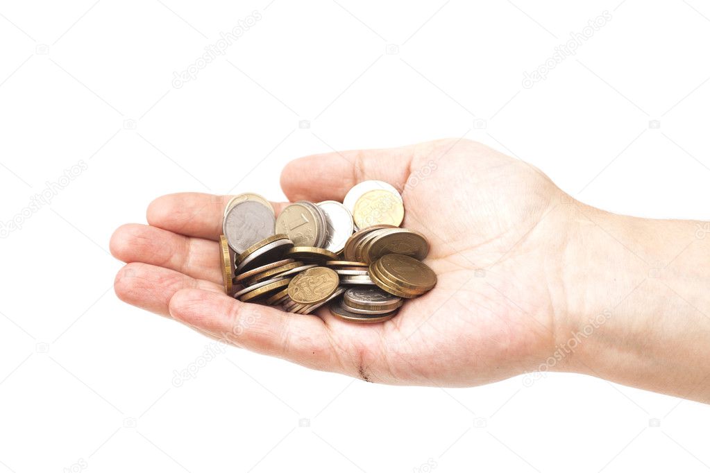 Handful of coins in palm hand isolated on white