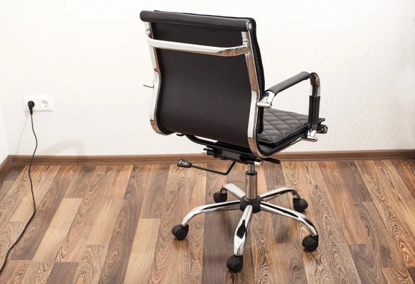 Black leather armchair in office room — Stock Photo, Image