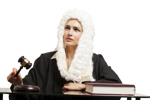 Female judge wearing a wig and black mantle with judge gavel and — Stock Photo, Image