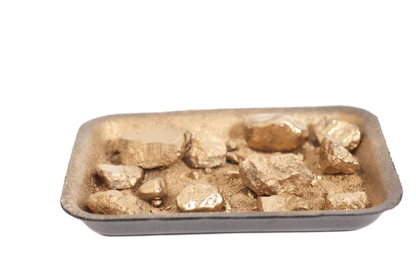 Golden nuggets on grungy wash pan with sand isolated — Stock Photo, Image