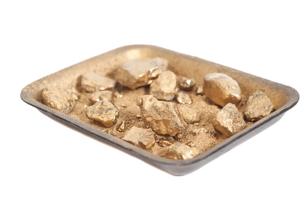 Golden nuggets on grungy wash pan with sand isolated — Stock Photo, Image