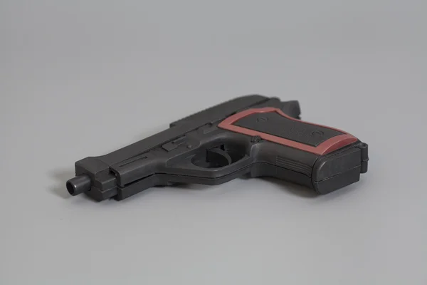 Pistola aislada sobre fondo gris — Foto de Stock