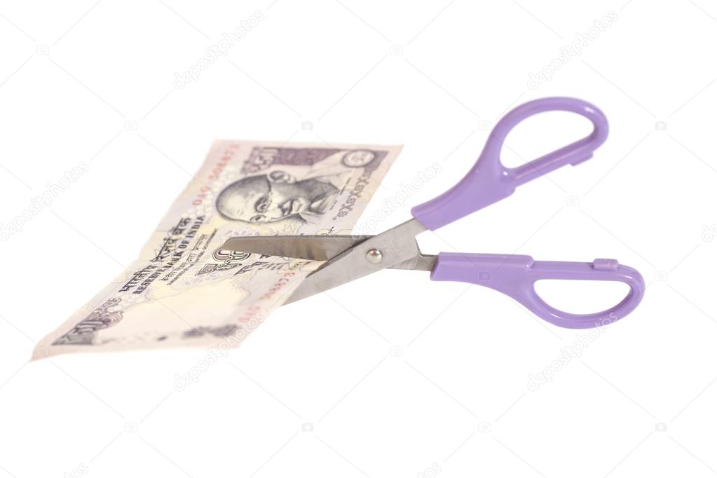 Fifty Rupee banknotes with scissors (Indian currency)