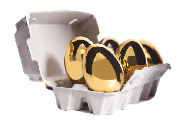 Золотые яйца в коробке — стоковое фото
