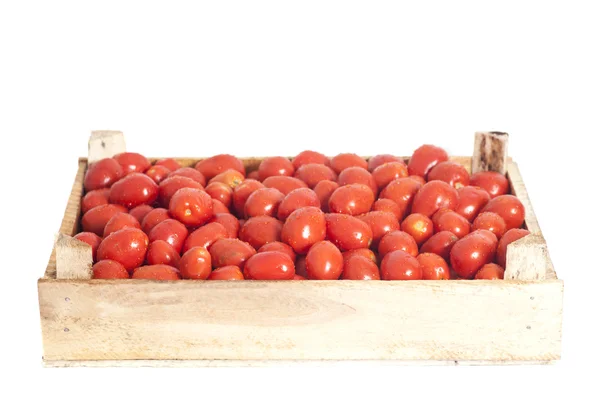 Mogna röda tomater i trälåda isolerad på vit — Stockfoto