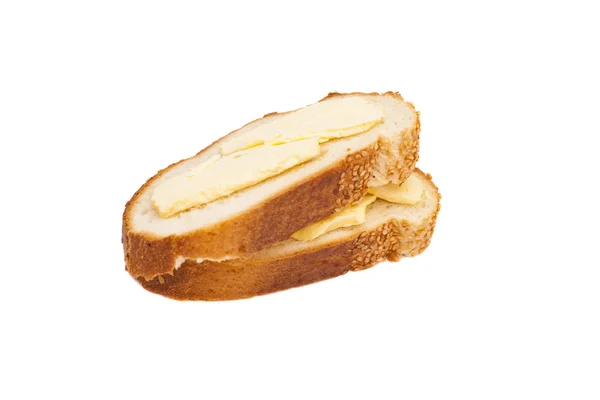 Duas fatias de pão de trigo espalhadas com manteiga — Fotografia de Stock