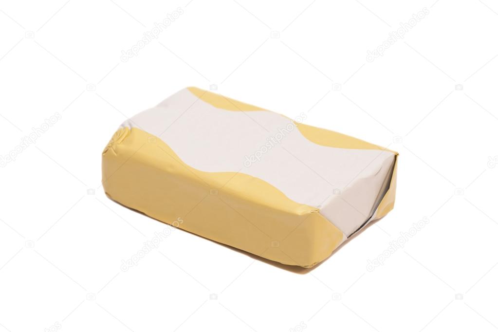 Stick of wrapped butter on white background 