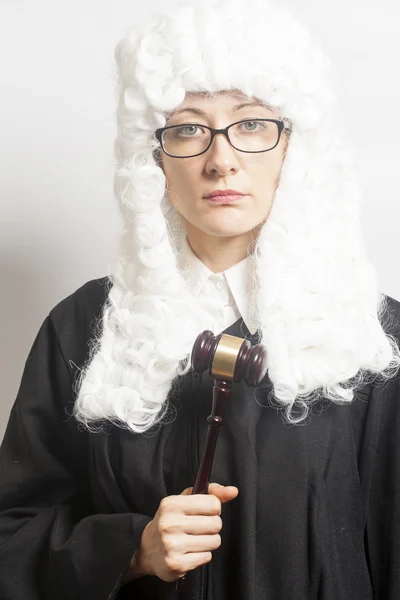 Female judge wearing a wig and Back mantle with eyeglasses holdi — Stock Photo, Image