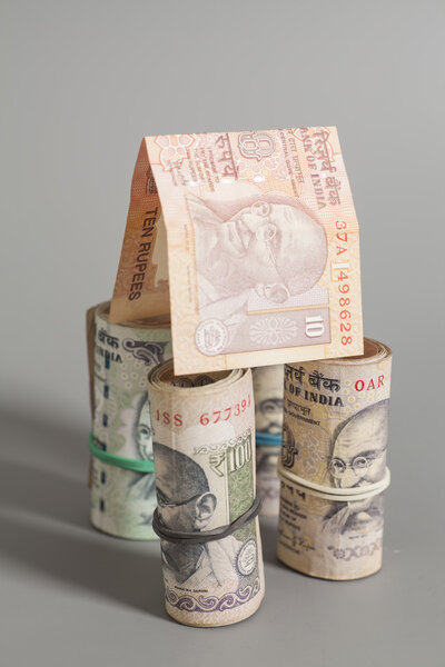 House Made Roll of Indian rupee banknotes isolated on gray