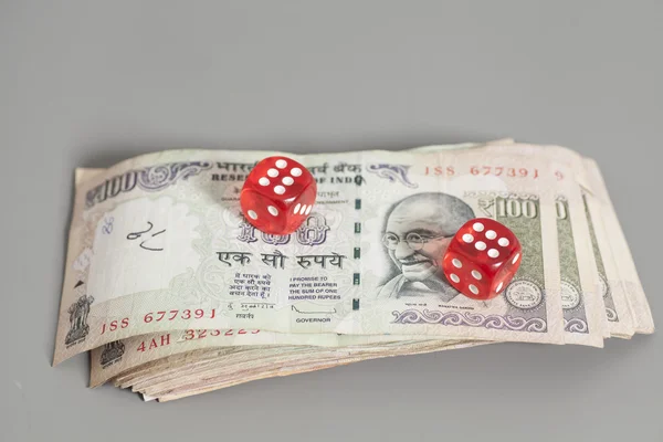 Red dice on Indian Currency Rupee bank notes